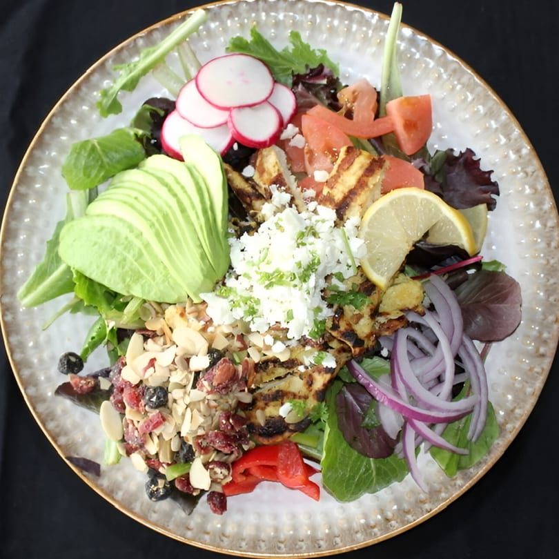Sage Social Eatery's grilled chicken salad with avocado, feta, radishes, and almonds.